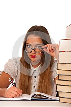 Stressed asian caucasian woman student learning in tons of books