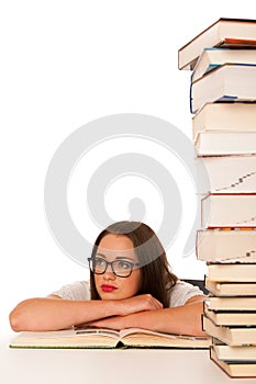 Stressed asian caucasian woman student learning in tons of books