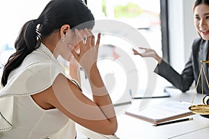 Stressed Asian female client in the meeting with her personal female lawyer