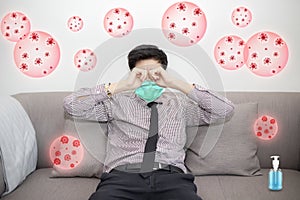 Stressed asian man sit on sofa wearing face mask for prevent coronavirus Covid-19. Concept stress and Job losses due to virus