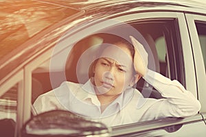 Stressed of asian woman driver sitting inside her car