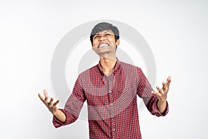 Stressed asian young man scream isolated on white