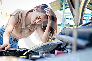 Stressed beautiful Asian woman car broken down on the side of the road