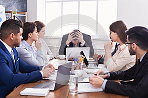 Stressed boss having problem at business meeting