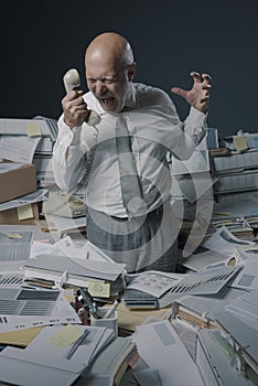 Stressed business executive overwhelmed by work