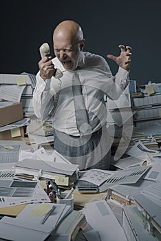 Stressed business executive overwhelmed by work photo