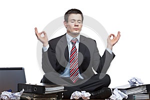 Stressed business man meditates at desk in office