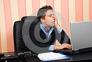 Stressed business man with problems at laptop