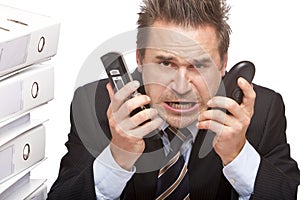 Stressed business man with telephones is crying photo