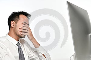 Stressed business man working on a computer