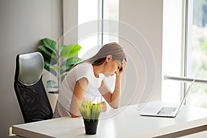 Stressed Business Woman Holding Her Head With Hand In