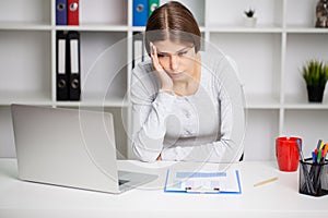 Stressed Business Woman Holding Her Head With Hand In Office