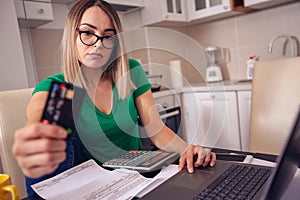 Stressed business woman at home working - paying bills e banking