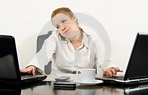 Stressed business woman multitasking in her office