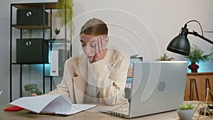 Stressed business woman worried about financial paperwork problem money debt budget loss at office