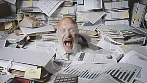 Stressed businessman buried under a lot of paperwork