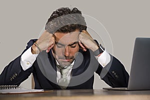 Stressed businessman feeling depressed and overwhelmed working at office computer desk tired and exhausted defeated by business f