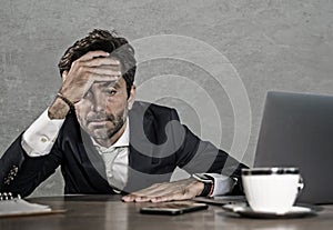 Stressed businessman feeling depressed and overwhelmed working at office computer desk tired and exhausted defeated by business f