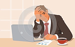 Stressed businessman with head in hands with laptop computer in his office