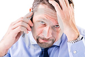 Stressed businessman making a phone call.