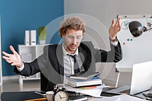 Stressed businessman missing deadlines in office