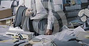 Stressed businessman overloaded with paperwork