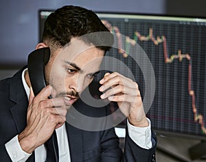 Stressed businessman on the phone, trading on the stock market during a financial crisis. Trader in a bear market with