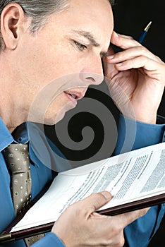 Stressed Businessman Reads Document