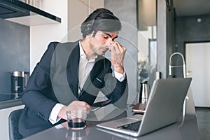 Stressed businessman with sight fatigue for display use photo