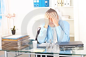 Stressed businessman sitting at desk