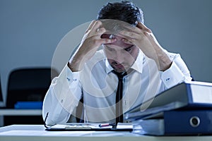 Stressed businessman sitting at desk