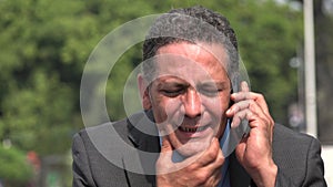 Stressed businessman talking on cell phone