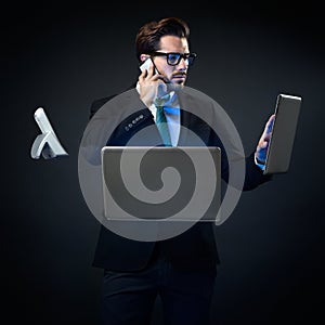 Stressed businessman talking on phone surrounded by technology.