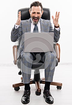 Stressed businessman using laptop to check email isolated on white. freelancer working online. Man has online blog