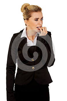 Stressed businesswoman biting her nails.