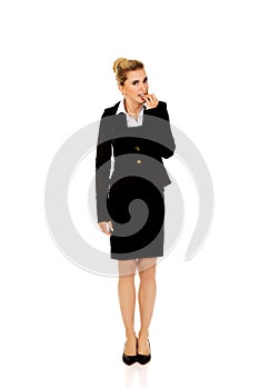 Stressed businesswoman biting her nails.