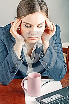 Stressed businesswoman holding disposable cup