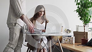 Stressed busy woman working hard pile paperwork files indoors office