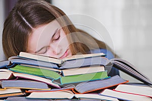 Stressed college student tired of hard learning with books in exams tests preparation