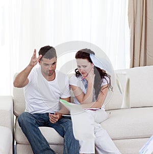 Stressed couple paying their bills