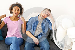 Stressed couple trying to refresh from hot weather