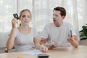 Stressed couple young family holding credit card for pay to so many expenses bills such as electricity bill,.water bill,internet