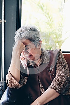 Stressed depressed fatigued sad upset asian old asian elderly senior elder woman