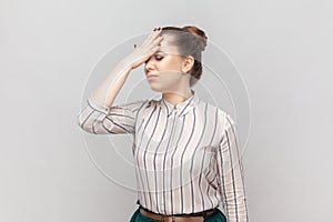 Stressed depressed woman standing showing facepalm gesture, forgot something important.