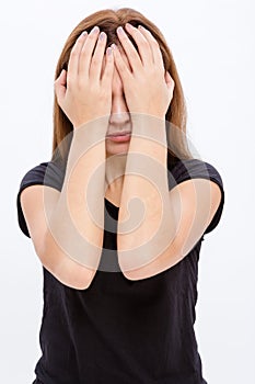 Stressed desperate young woman covered eyes by hands