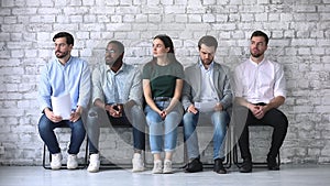 Stressed diverse ethnicity business people applicants waiting for job interview