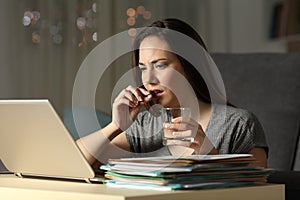 Entrepreneur working late hours taking painkiller pill photo