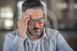 Stressed ethnic man with headache