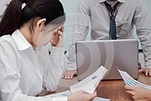 Stressed exhausted young Asian business woman suffering from severe depression between meeting in office.