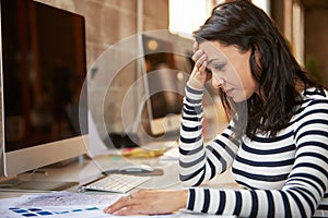 Stressed Female Designer Works At Computer In Modern Office